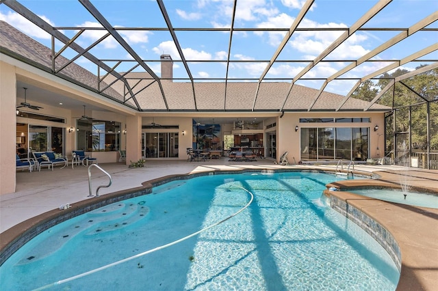 view of pool featuring pool water feature, ceiling fan, a lanai, and a patio