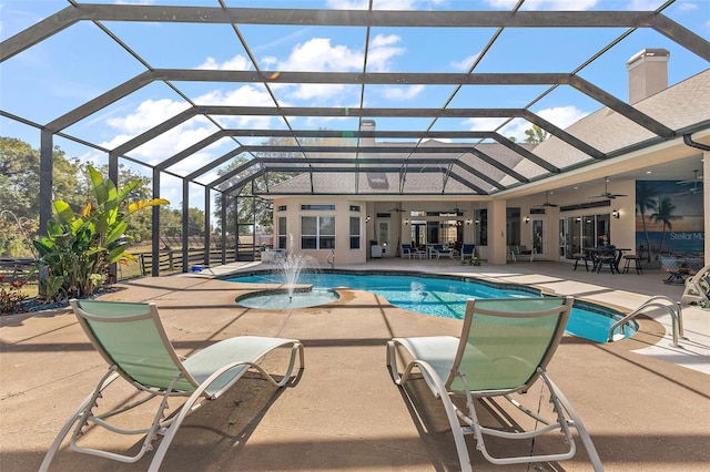 view of pool with pool water feature, a patio, a lanai, and ceiling fan