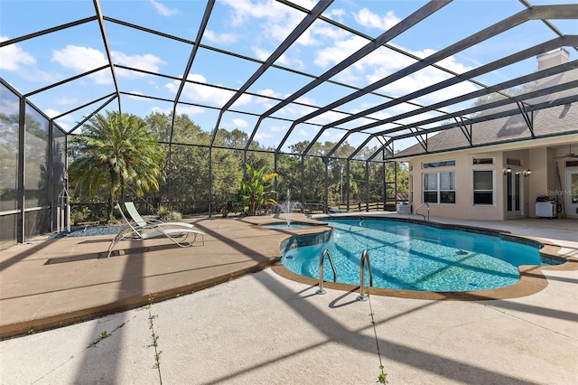 view of swimming pool featuring an in ground hot tub, a lanai, pool water feature, and a patio