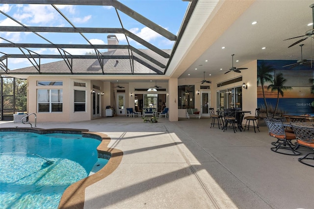 view of pool featuring a lanai, a patio, and ceiling fan