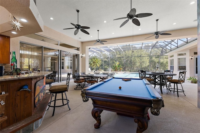 playroom with a high ceiling, a wealth of natural light, a textured ceiling, and pool table