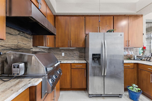 kitchen featuring stainless steel fridge and decorative backsplash