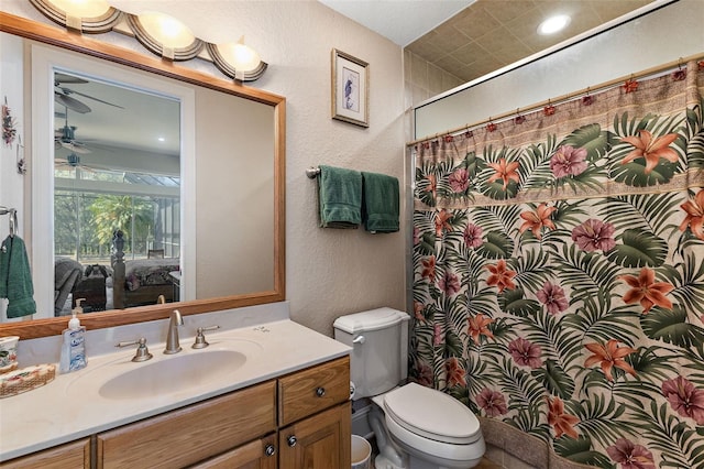 bathroom featuring ceiling fan, vanity, toilet, and a shower with shower curtain