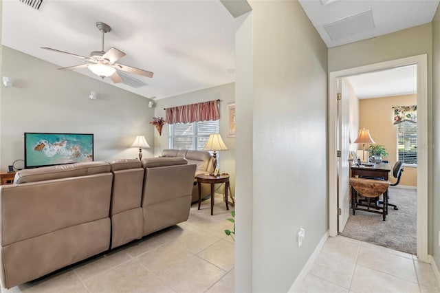 tiled living room with lofted ceiling and ceiling fan