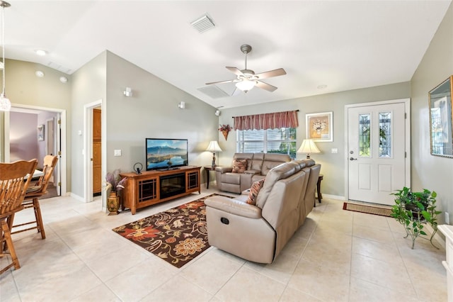 living room featuring ceiling fan, vaulted ceiling, and light tile patterned floors