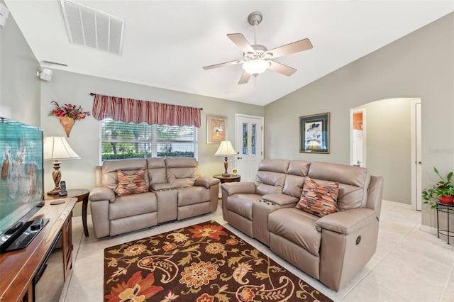 tiled living room featuring ceiling fan and vaulted ceiling