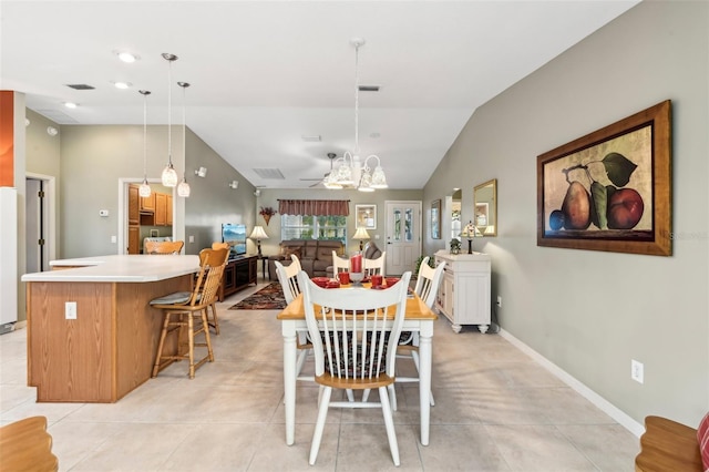 tiled dining room with an inviting chandelier and vaulted ceiling