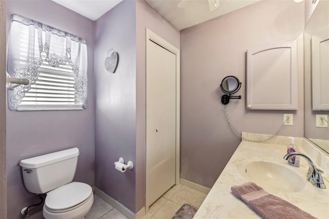 bathroom featuring vanity, tile patterned floors, and toilet