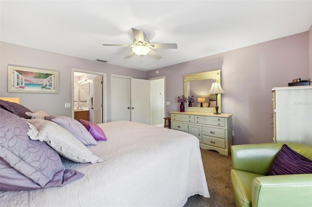 bedroom with ceiling fan, carpet flooring, and ensuite bath