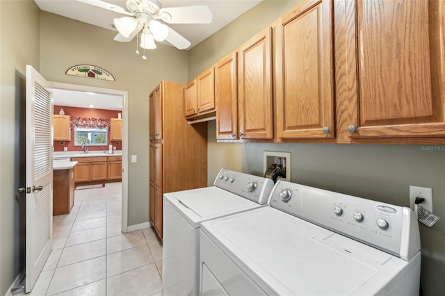 washroom featuring light tile patterned flooring, sink, cabinets, ceiling fan, and washer and clothes dryer