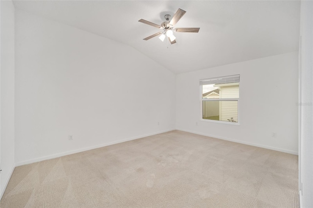 empty room with light carpet, lofted ceiling, and ceiling fan