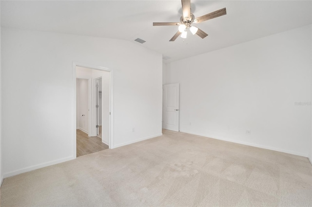 carpeted empty room with ceiling fan and vaulted ceiling