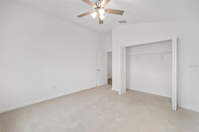 unfurnished bedroom featuring lofted ceiling, light carpet, ceiling fan, and a closet