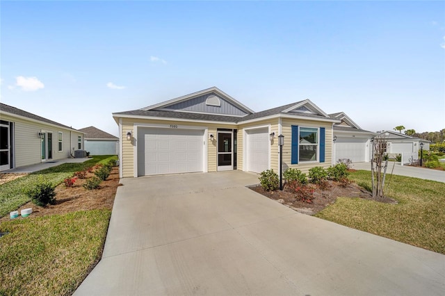 single story home with a garage, a front yard, and central AC unit