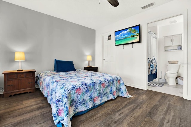 bedroom featuring ceiling fan, dark hardwood / wood-style floors, and ensuite bath