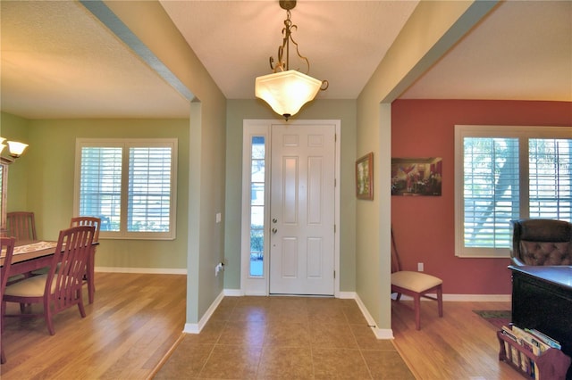 entryway with hardwood / wood-style flooring and a wealth of natural light