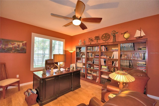 office space featuring ceiling fan and light hardwood / wood-style floors