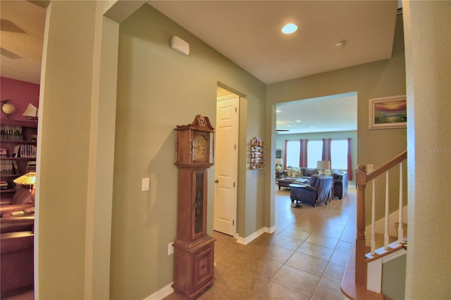 hall featuring light tile patterned floors