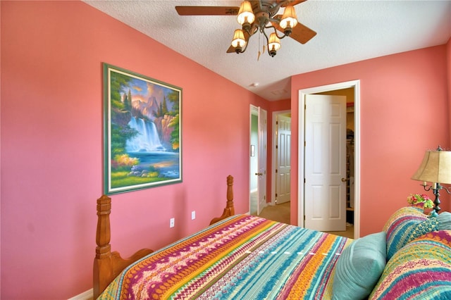 bedroom with ceiling fan and a textured ceiling