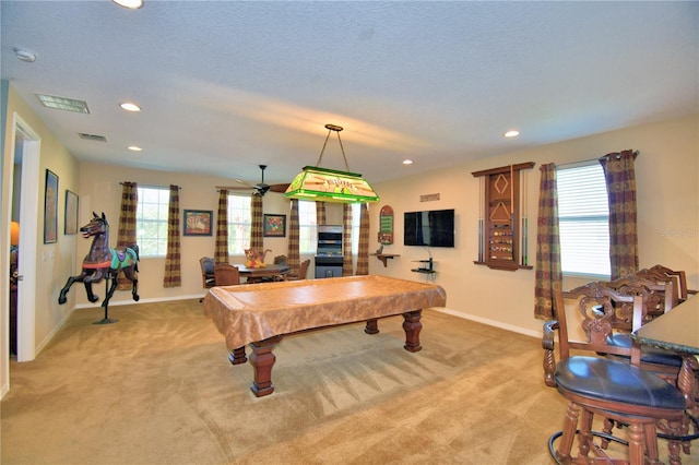 game room with light colored carpet, a textured ceiling, and pool table