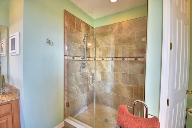 bathroom with vanity and a shower with shower door