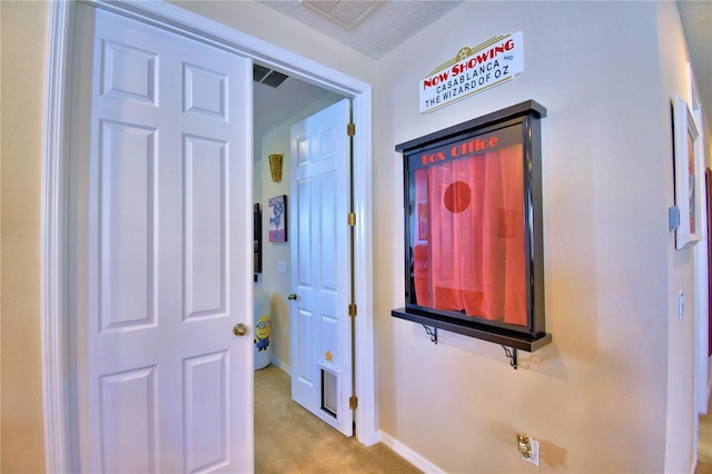 hallway with light colored carpet