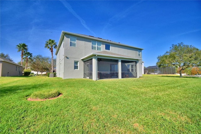 back of property featuring cooling unit, a yard, and a sunroom