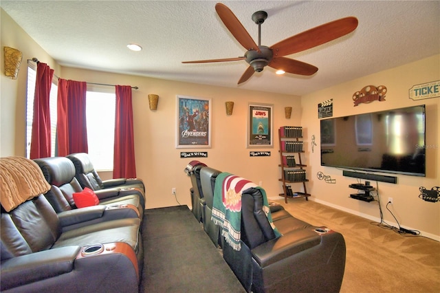 carpeted cinema featuring ceiling fan and a textured ceiling