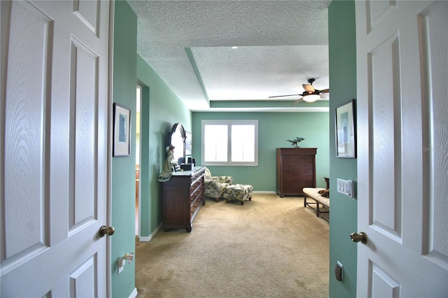 carpeted bedroom with ceiling fan and a textured ceiling