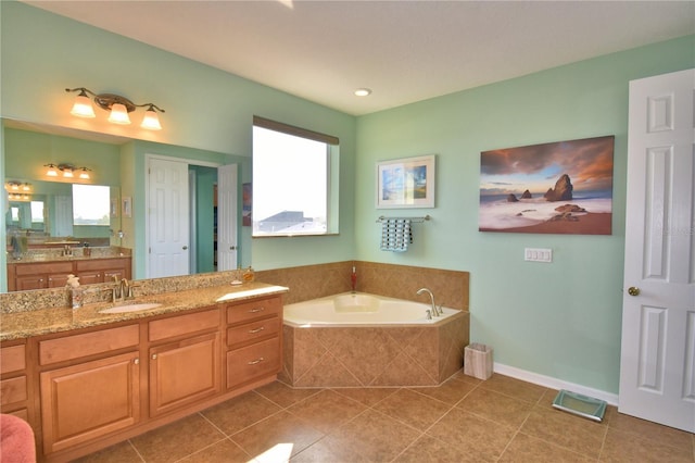 bathroom featuring vanity, tiled tub, plenty of natural light, and tile patterned floors