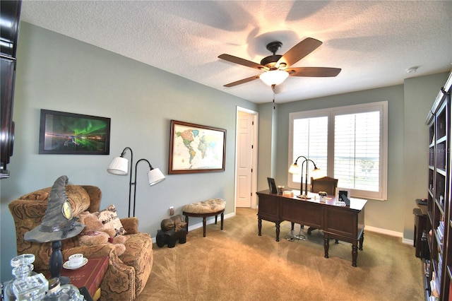 carpeted office space featuring ceiling fan and a textured ceiling