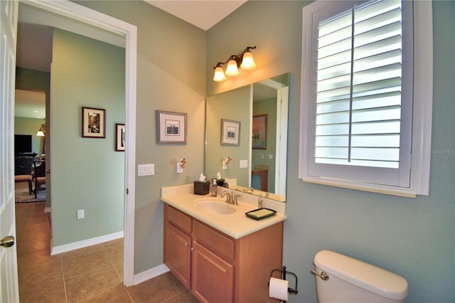 bathroom featuring vanity, tile patterned floors, and toilet