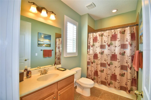 full bathroom with shower / bathtub combination with curtain, tile patterned flooring, vanity, a textured ceiling, and toilet