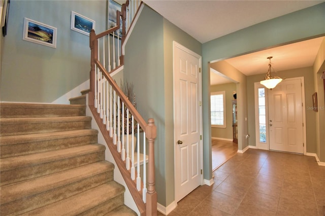 foyer entrance with dark tile patterned flooring