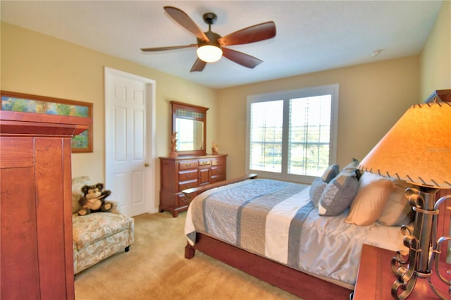 bedroom with light colored carpet and ceiling fan