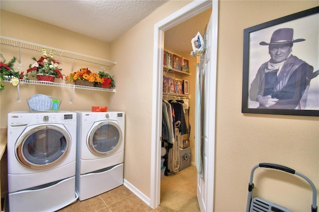 washroom featuring light tile patterned floors, a textured ceiling, and independent washer and dryer