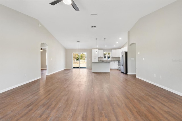 202 Shannon Ln, Lady Lake, FL 32159 - unfurnished living room featuring dark hardwood / wood-style flooring, high vaulted ceiling, and ceiling fan