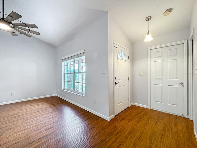 foyer entrance with ceiling fan, vaulted ceiling, and wood-type flooring