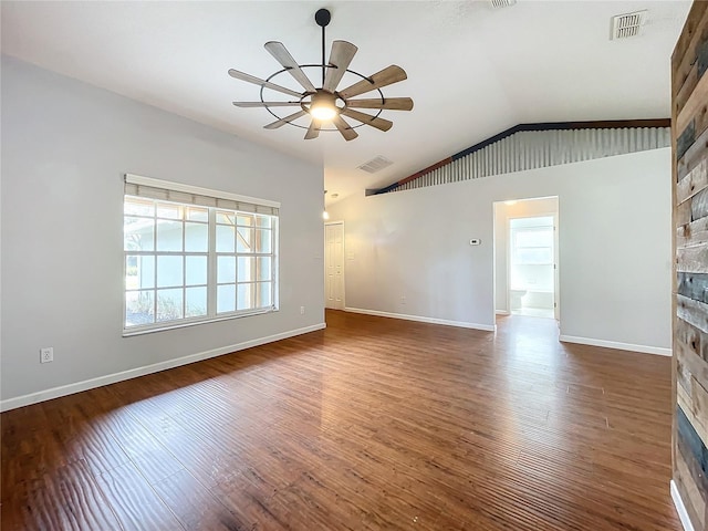 unfurnished living room featuring ceiling fan, dark hardwood / wood-style flooring, and vaulted ceiling