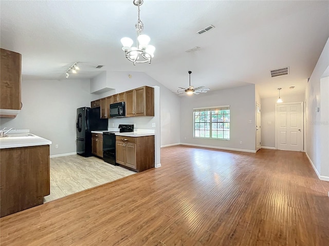 kitchen featuring sink, ceiling fan with notable chandelier, light hardwood / wood-style floors, and black appliances