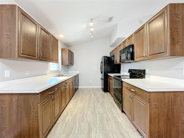 kitchen with sink, track lighting, and black appliances