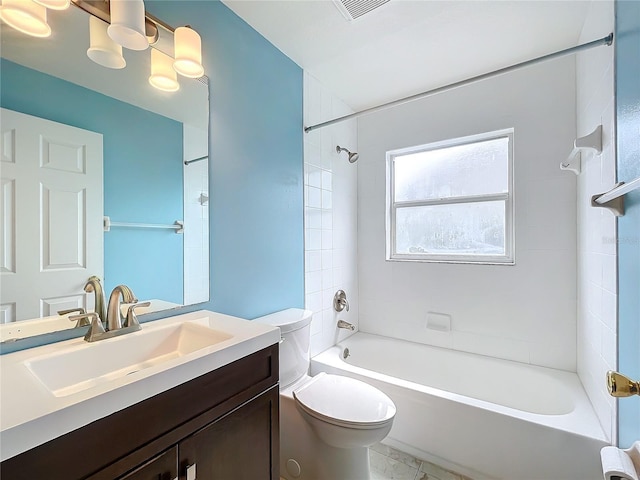 full bathroom featuring vanity, tiled shower / bath combo, and toilet