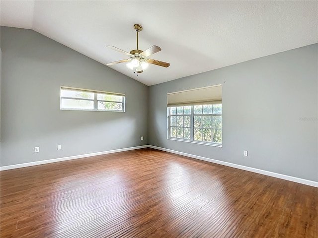 empty room with ceiling fan, wood-type flooring, and vaulted ceiling