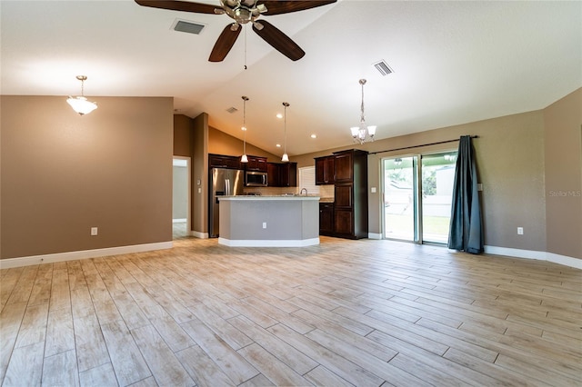 unfurnished living room with lofted ceiling, ceiling fan with notable chandelier, and light hardwood / wood-style flooring