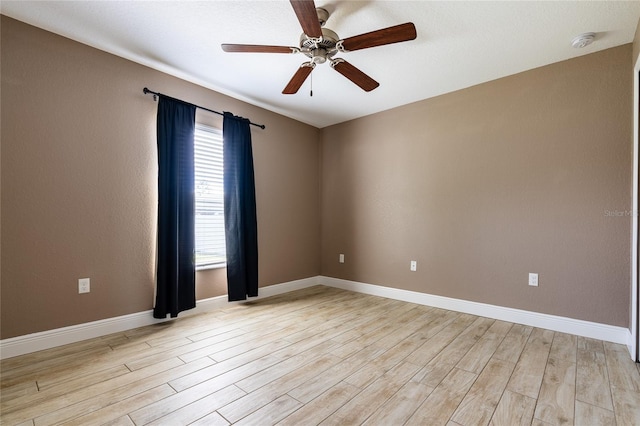 spare room featuring ceiling fan and light wood-type flooring