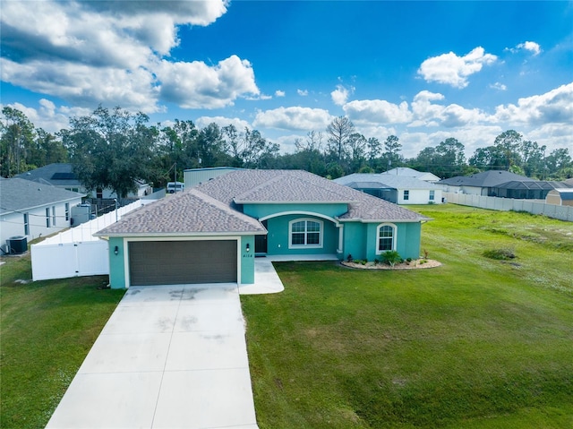 view of front facade featuring cooling unit, a garage, and a front yard