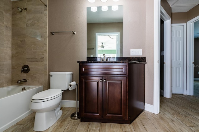 bathroom with vanity, wood finished floors, a ceiling fan, and toilet
