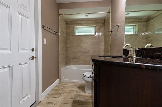 full bathroom featuring toilet, vanity,  shower combination, and wood finish floors