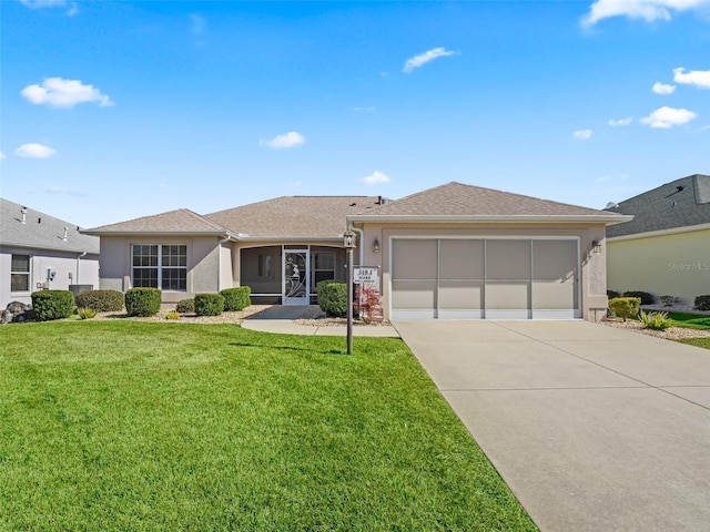 ranch-style home featuring a garage and a front lawn