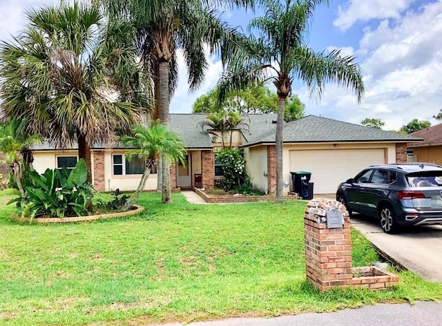 single story home featuring a garage and a front lawn